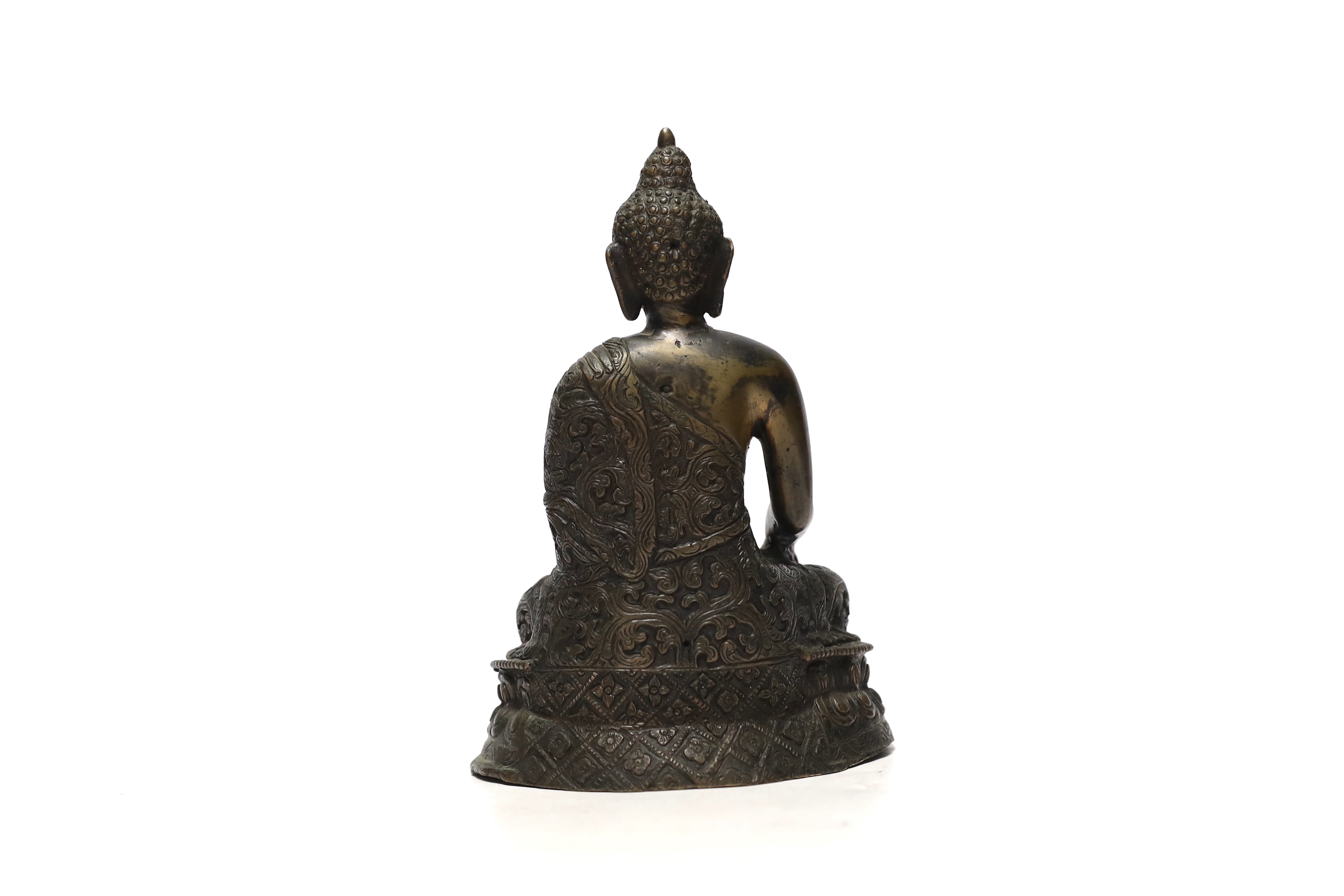 A South East Asian bronze model of a seated Buddha, 20cm